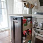 A kitchen stove with a pull-out drawer for spices